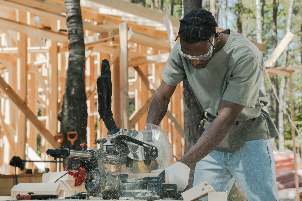 Man Cutting Wood Using Circular Saw